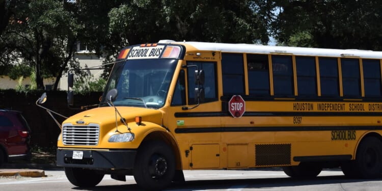 A Houston school bus charter near a water fountain in Houston, Texas.
