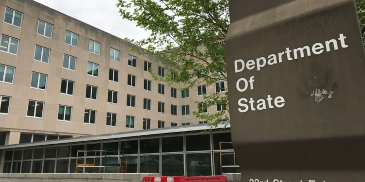 A sign for the Department of State stands outside a US diplomacy building in Washington, DC on April 19, 2019.