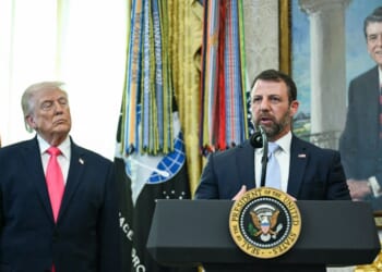 President Donald Trump looks on as newly sworn in Secretary of Homeland Security Markwayne Mullin speaks in the Oval Office of the White House in Washington, D.C., on March 24, 2026.