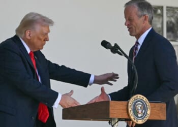 President Donald Trump shakes Senate Majority Leader John Thune's hand during an October event at outside the White House.