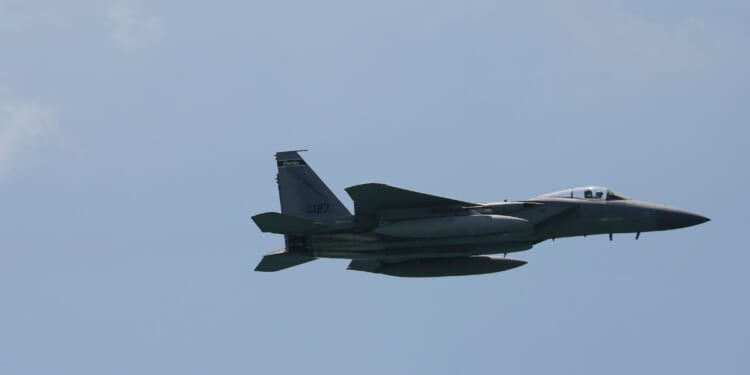 A F-15 fighter jet maneuvers before the Hyundai Air and Sea Show on May 28, 2021 in Miami Beach, Florida.