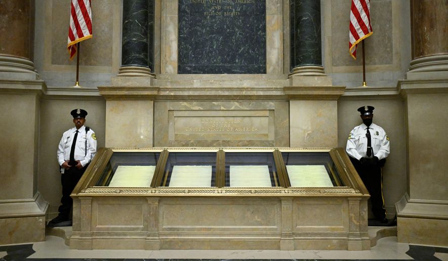 FILE - Two guards stand their posts at the cases containing the United States Constitution at the National Archives Jan. 29, 2026, in Washington. (AP Photo/John McDonnell, File)