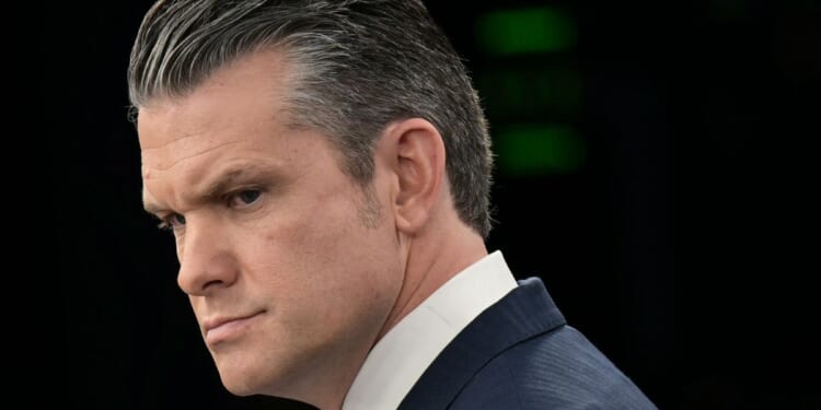 U.S. Secretary of War Pete Hegseth looks on during a news briefing at the Pentagon in Washington, DC on March 31, 2026.