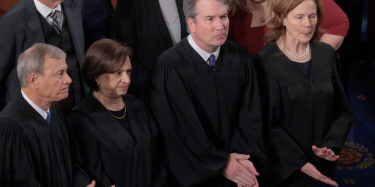 WASHINGTON, DC - FEBRUARY 24: U.S. Supreme Court Chief Justice John Roberts and Associate Justices Elena Kagan, Brett Kavanaugh and Amy Coney Barrett applaud at the conclusion of President Donald Trump's State of the Union address during a joint session of Congress at the Capitol on February 24, 2026, in Washington, DC. Trump delivered his address days after the Supreme Court struck down the administration's tariff strategy and amid a U.S. military buildup in the Persian Gulf threatening Iran. (Photo by Chip Somodevilla/Getty Images)