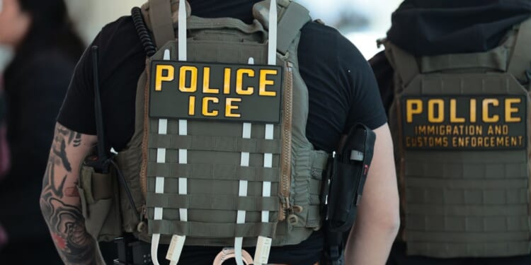Immigration and Customs Enforcement agents walk through Terminal C at LaGuardia Airport in New York on March 24, 2026.