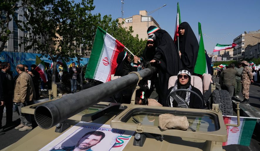 Women members of the Basij paramilitary, affiliated with Iran's Revolutionary Guard, march with their weapons during a state-organized rally in support of the supreme leader marking National Girl's Day in Tehran, Iran, Friday, April 17, 2026. (AP Photo/Vahid Salemi)