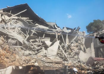 Emergency crews work at the site of a U.S.-Israeli strike Tuesday on what was described as a residential building adjacent to Rafi-Nia Synagogue in Tehran, Iran.