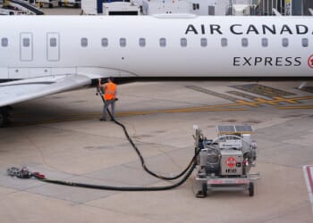 A worker fuels an Air Canada plane on April 14, 2026.