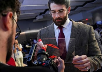 Streamer Hasan Piker signs a panel April 7 in front of a camera lens during a campaign event for Abdul El-Sayed, a progressive candidate in the Democratic primary for U.S. Senate in Michigan.