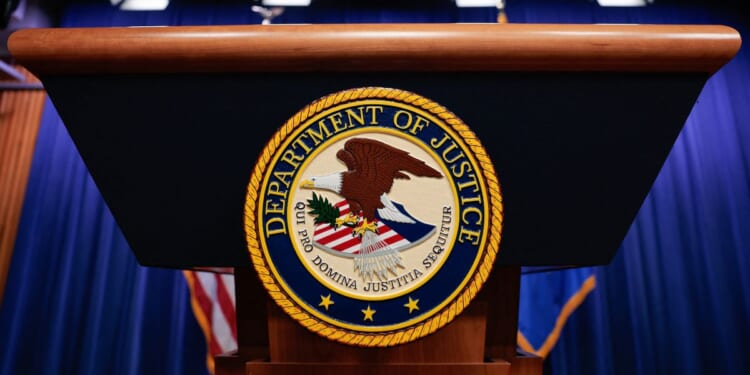 The seal of the Department of Justice sits on a podium in the Department of Justice headquarters in Washington, DC on April 7, 2026.