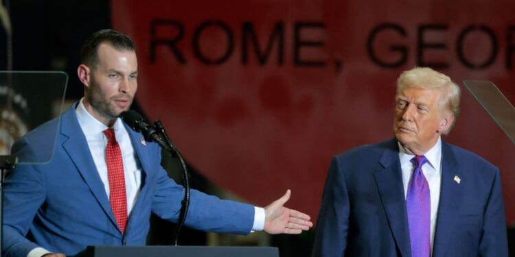 President Donald Trump looks on as Republican congressional candidate Clay Fuller speaks at the Coosa Steel Corporation on Feb. 19, 2026, in Rome, Georgia.