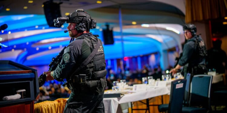 Armed secret service agents flood the stage of the White House Correspondents’ Dinner on April 25, 2026.