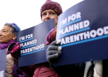 Planned Parenthood protesters stand outside of Moakley Federal Courthouse on November 12, 2025.