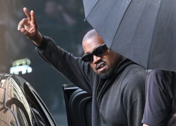 U.S. rapper and producer Kanye West gestures upon arriving at Shanghai Pudong International Airport on July 11.