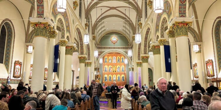 An audience waits in St Francis Cathedral for a Christmas concert to start on Dec. 9, 2025, in Santa Fe, New Mexico.