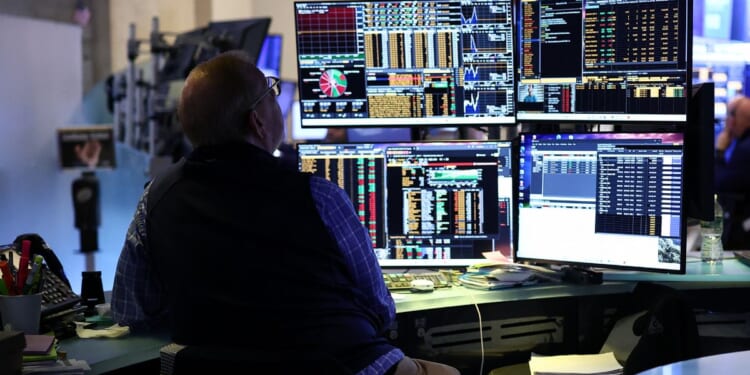 A trader works on the floor of the New York Stock Exchange during the opening bell in New York, on April 13, 2026.