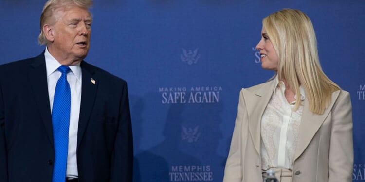 President Donald Trump interacts with then-Attorney General Pam Bondi March 23 at a "Making America Safe Again" meeting at the Memphis International Airport in Memphis, Tennessee.