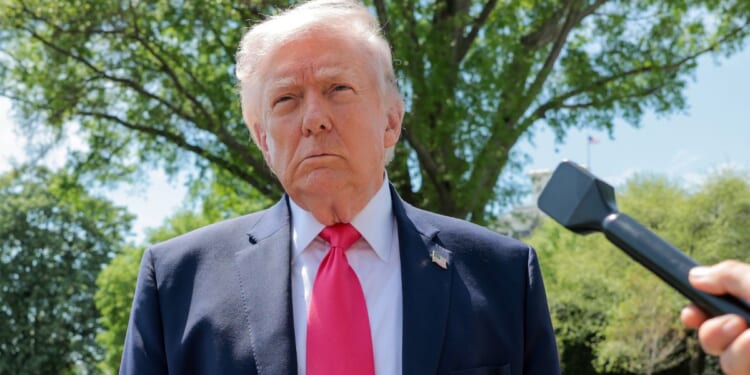 President Donald Trump speaks to the media Thursday before boarding Marine One on the South Lawn of the White House.