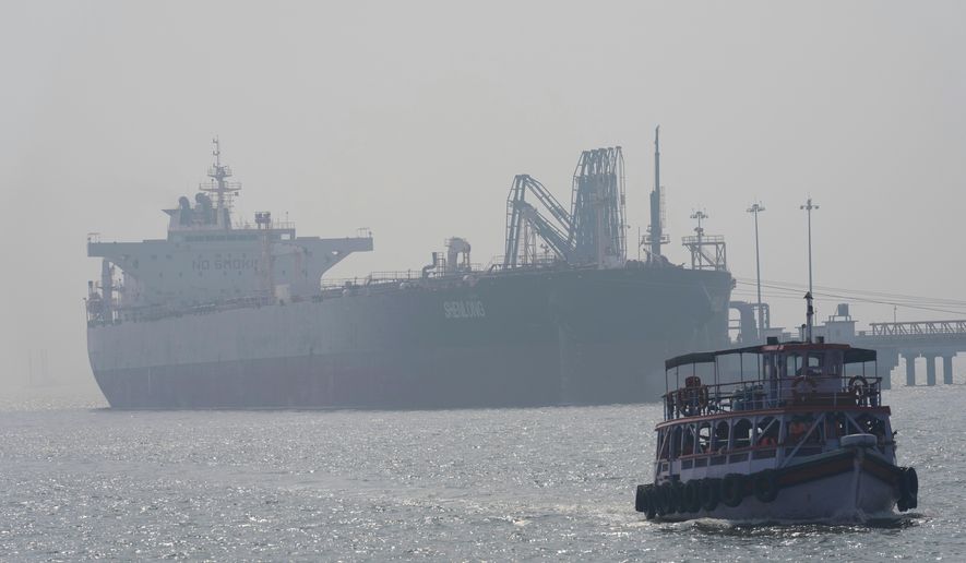 Liberia-flagged tanker Shenlong Suezmax, carrying crude oil from Saudi Arabia, that arrived clearing the Strait of Hormuz, is seen at the Mumbai Port in Mumbai, India, Thursday, March 12, 2026. (AP Photo/Rafiq Maqbool)