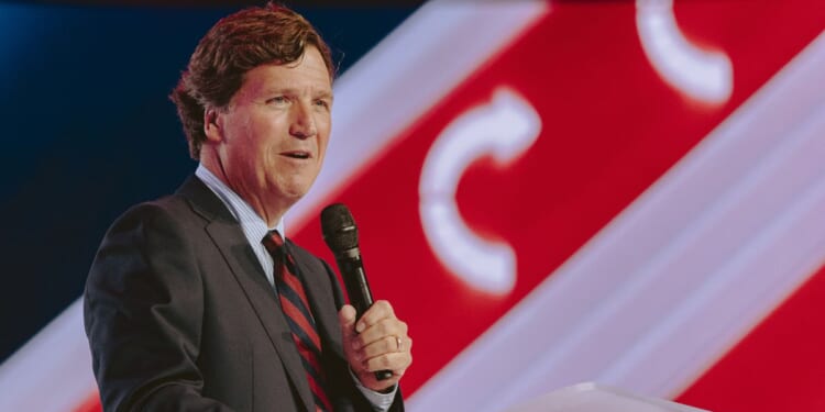 Conservative political commentator and podcast host Tucker Carlson speaks at Turning Point's annual AmericaFest conference, in remembrance of late right-wing political activist Charlie Kirk, in Phoenix, Arizona, on Dec. 18, 2025.