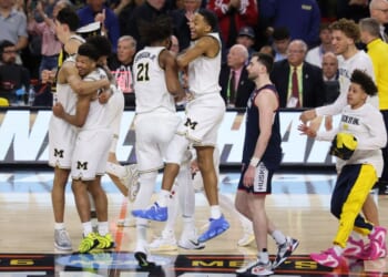 The Michigan Wolverines celebrate after defeating the UConn Huskies 69-63 in the National Championship of the 2026 NCAA Men's Basketball Tournament Monday in Indianapolis, Indiana.