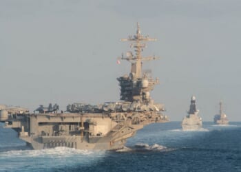 The USS Abraham Lincoln is pictured in a file photo from the Strait of Hormuz in November 21019. It is accompanied by the Royal Navy air defense destroyer HMS Defender and the guided-missile destroyer USS Farragut.