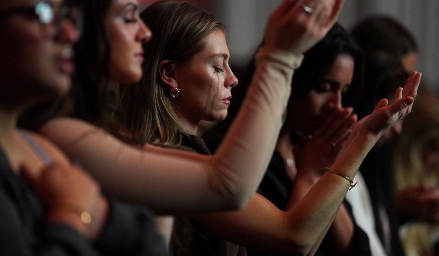 Followers of the Christian podcast, "Girls Gone Bible," cry during the live show held at the Atlanta Symphony Hall, Nov. 14, 2025, in Atlanta. (AP Photo/Jessie Wardarski, File)