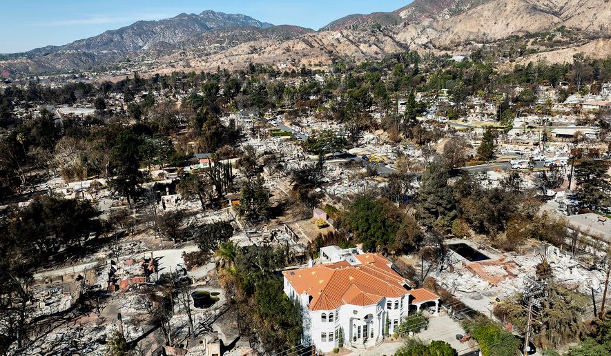 A lone home stands among residences leveled by the Eaton Fire in Altadena, Calif., Jan. 21, 2025. (AP Photo/Noah Berger, File)