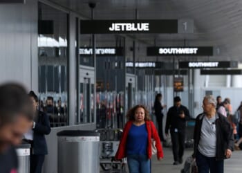 Travelers walk with their bags at Los Angeles International Airport on March 31, 2026, in Los Angeles, California.