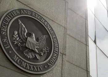 SEC, DOJ charge 21 in scheme that netted millions in illicit trading profits