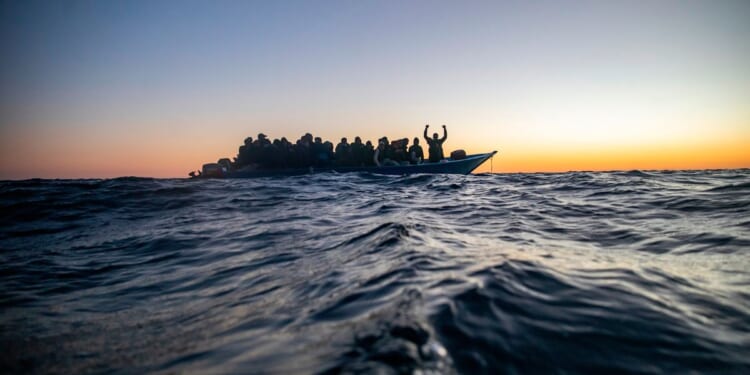 Aid group says Libyan-linked vessels fired on a migrant rescue ship in the Mediterranean