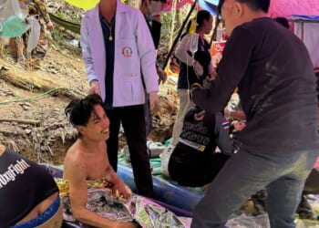 Rescuers free 4 men who had been trapped in a flooded Laos cave, search for 2 still missing