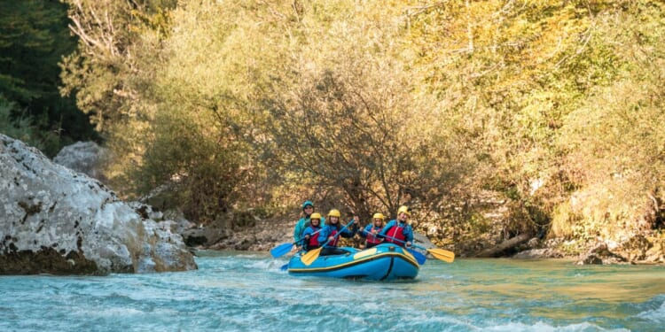 A young family with a mother guiding her three kids on a rafting expedition.
