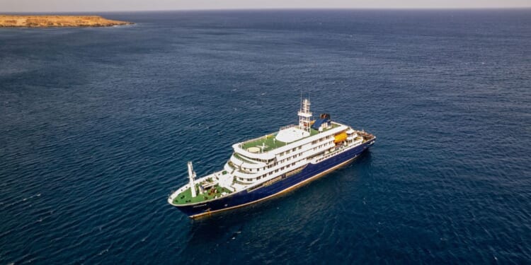 This aerial picture shows a general view of the cruise ship MV Hondius stationary off the port of Praia, the capital of Cape Verde, on May 3, 2026.