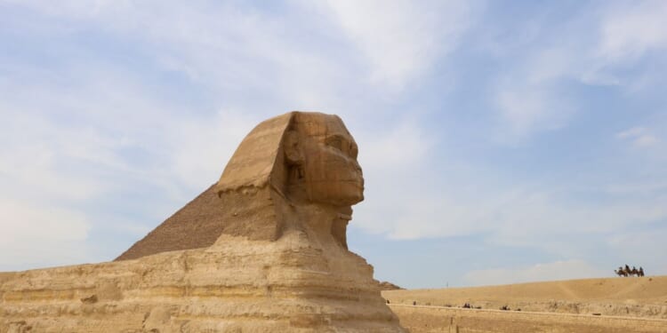 Tourists ride camels near the Sphinx and the Pyramid of Khafre or Chephren, a UNESCO World Heritage site, in Giza on the outskirts of Cairo, Egypt, on Feb. 25, 2025.