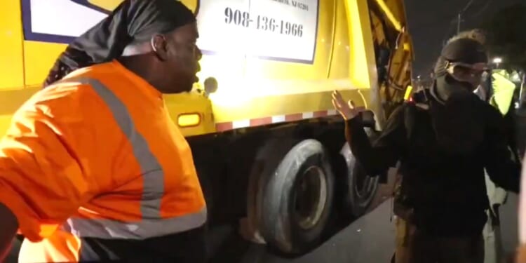 A truck driver gives a masked protester an earful after traffic was halted,