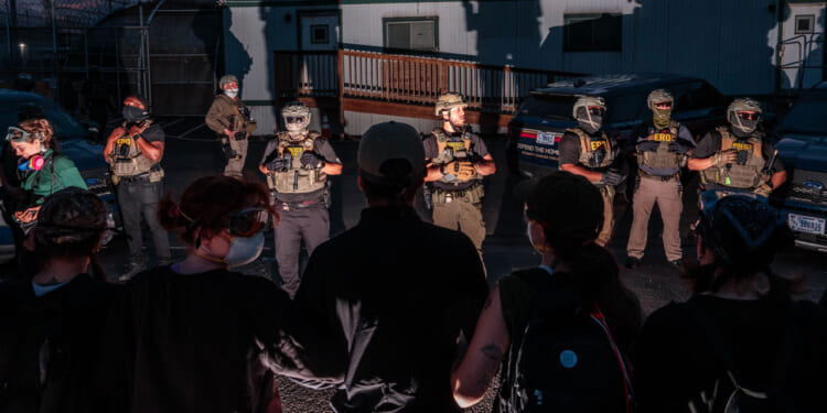 Protesters face off with ICE agents outside the federal immigration center at Delaney Hall, where ICE is housing detained immigrants on May 27, 2026 in Newark, New Jersey. The ongoing protests, which became tense over the holiday weekend, come amid reports of a hunger strike by detainees. (Photo by Adam Gray/Getty Images)