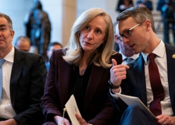 Former Virginia Governor Ralph Northam, then-Governor-elect Abigail Spanberger, and Representative James Walkinshaw sit together at an unveiling ceremony for the statue of a civil rights leader in Emancipatino Hall in the U.S. Capitol Visitors Center in Washington on Dec. 16, 2025.