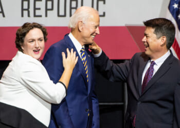 Former Vice President Joe Biden, center, shares a laugh with congressional candidates, Katie Porter, left, and TJ Cox, right.