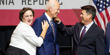 Former Vice President Joe Biden, center, shares a laugh with congressional candidates, Katie Porter, left, and TJ Cox, right.
