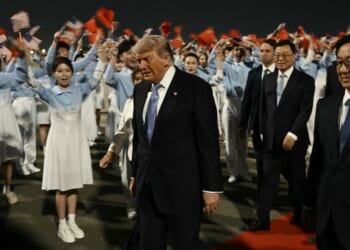 President Donald Trump is escorted by China's Vice President Han Zheng, right, upon his arrival at Beijing Capital Airport Wednesday.