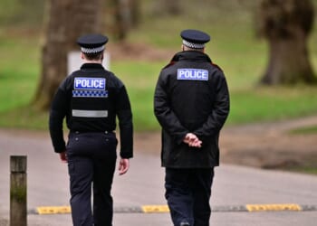 Police officers walk through the Bishops Gate entrance leading to Royal Lodge, a 30-room property and former residence to Britain's former prince Andrew where police said they are still conducting a search, in Windsor, west of London, on Feb. 20, 2026.