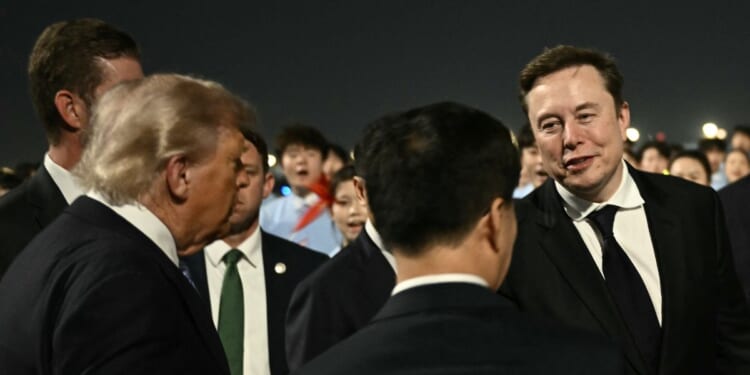 President Donald Trump presents SpaceX, Twitter and electric car maker Tesla CEO Elon Musk to China's Vice President Han Zheng at Beijing Capital Airport in Beijing on May 13, 2026.