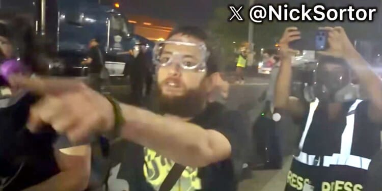 A foul-mouthed protester screams death threats against a law officer's family in video posted to social media Thursday.