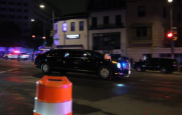 A vehicle of a motorcade flees into the night after the White House Press Correspondents’ Dinner incident.