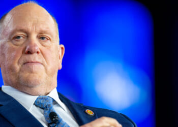 Close-up of Tom Homan against a blue backdrop.