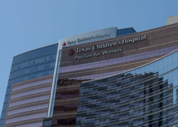 Low-angle shot of Texas Children's Hospital against a blue sky.