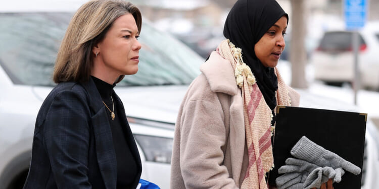 Ilhan Omar (D-MN) (R) and Angie Craig (D-MN) walk to the Bishop Henry Whipple Federal building.