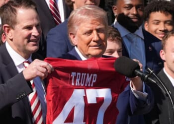 Indiana Hoosiers coach Curt Cignetti, left, presents President Donald Trump a jersey during an event to welcome the 2026 College Football Playoff national champions Indiana University on the South Lawn of the White House, Monday.