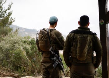 Israeli soldiers take a position along the Israel-Lebanon border on March 7, 2026.